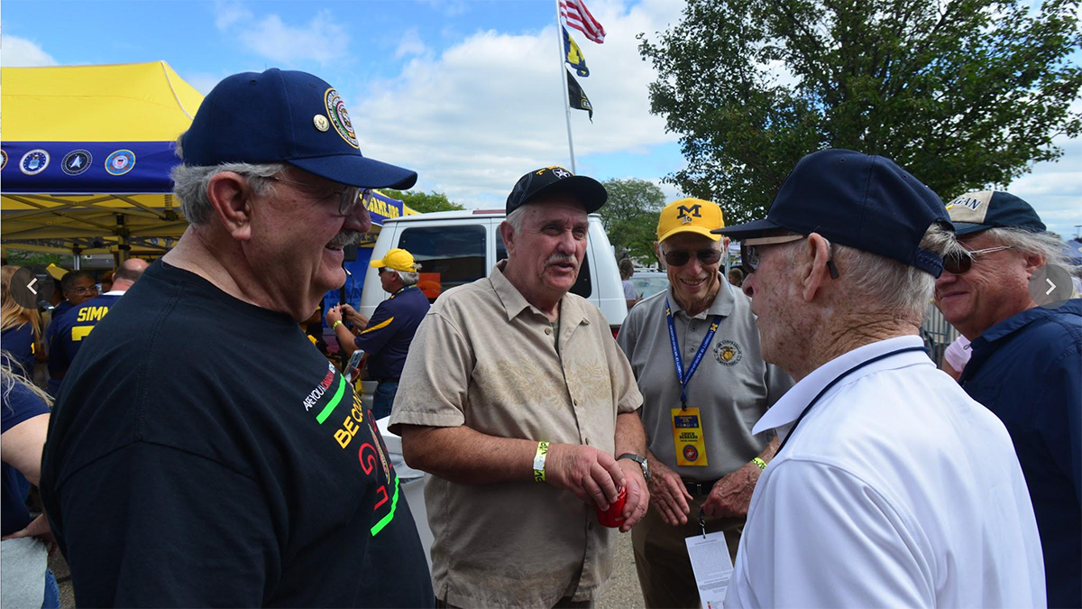 carmelo talking with other vets at tailgate