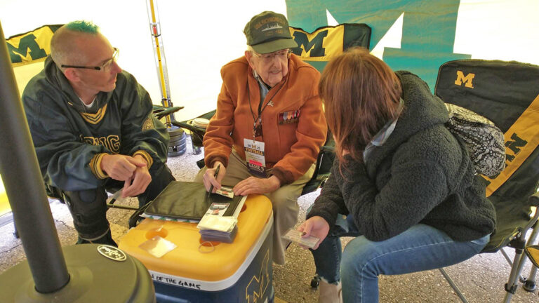 michael talking with people in tent